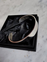 Load image into Gallery viewer, A Heavy Silver Cuff by Kathrin Jona in a black box.
