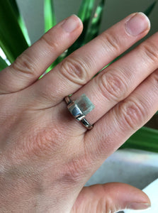 A woman's hand holding a Light Blue Aquamarine Ring by Kathrin Jona.