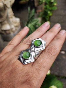 A woman's hand holding a Green Shield Jadeite Ring #2 by Kathrin Jona.