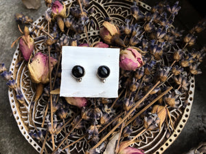 Sheen Obsidian stud earrings by Kathrin Jona on a plate.