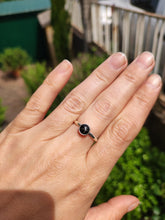 Load image into Gallery viewer, A woman&#39;s hand holding a Round Obsidian Silver Stacker Ring by Kathrin Jona.
