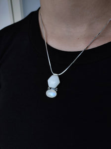 A woman is wearing a Kathrin Jona Mother of Pearl and Moonstone Necklace.