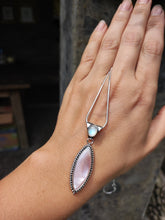 Load image into Gallery viewer, A woman&#39;s hand holding a Mother of Pearl Granulation Necklace by Kathrin Jona with a pink stone.
