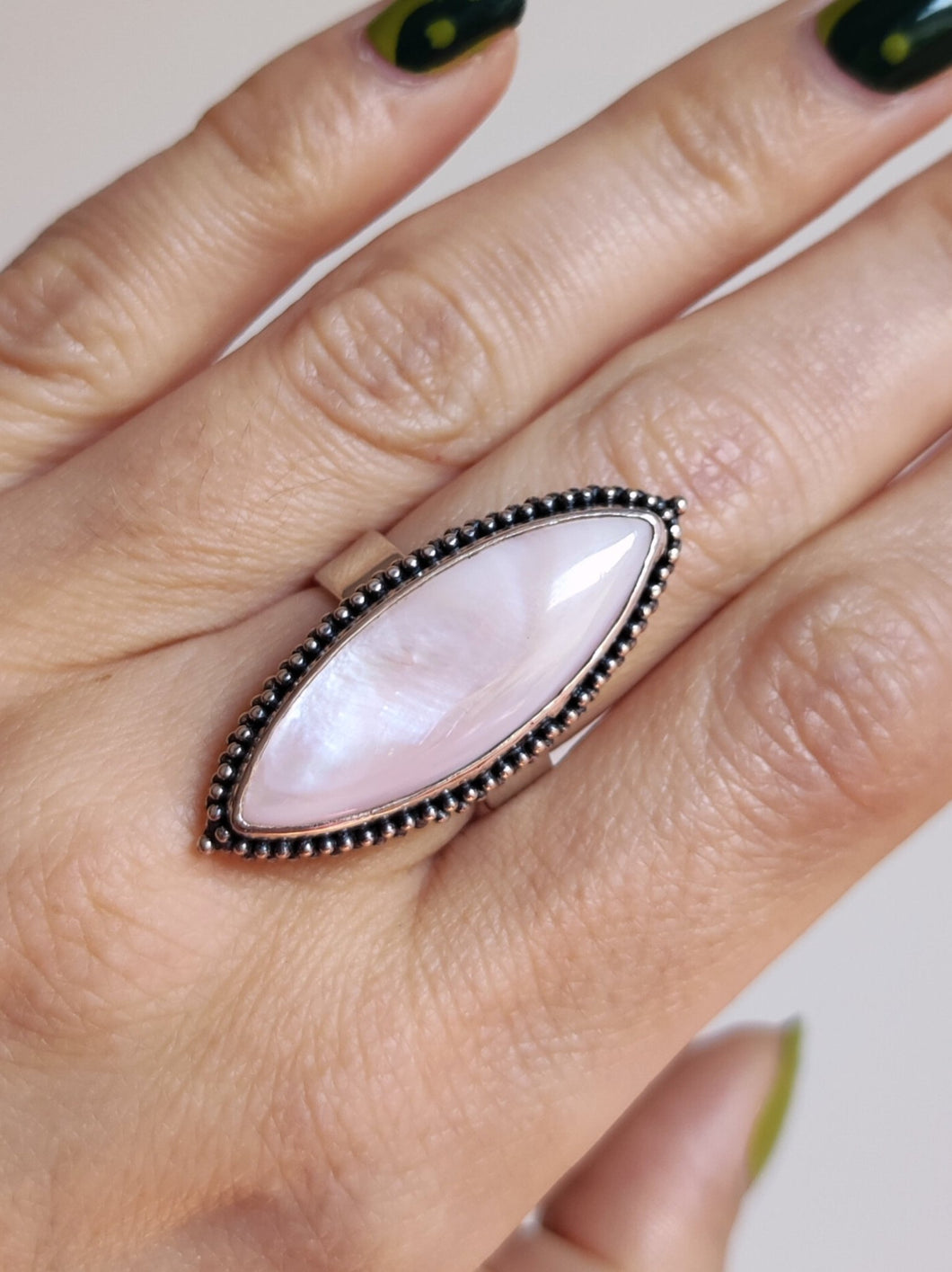 A woman's hand with a pink Kathrin Jona Mother of Pearl Granulation Ring adjustable.