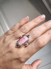 Load image into Gallery viewer, A woman&#39;s hand holding a Rhodochrosite Statement Ring by Kathrin Jona.

