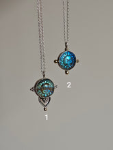 Load image into Gallery viewer, Explore two sun-themed necklaces on chains: The first features a teardrop pendant crafted from recycled silver with an ornate design, while the second, the Kathrin Jona Fair Labradorite Sun Face Necklace, showcases a round blue sun face adorned with minimal upcycled gold accents.
