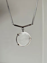 Load image into Gallery viewer, The Clear Quartz Moto Necklace by Kathrin Jona features a clear circular pendant on a recycled silver chain, showcasing a minimalist design against a neutral background.
