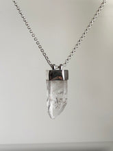 Load image into Gallery viewer, The Australian Clear Quartz Necklace #2 by Kathrin Jona showcases a clear Quartz crystal pendant on a silver chain, elegantly crafted from recycled silver and displayed against a plain background.
