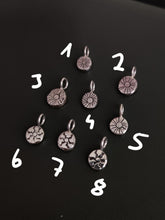 Load image into Gallery viewer, A group of Kathrin Jona sterling silver &#39;SUN&#39; charms with numbers.
