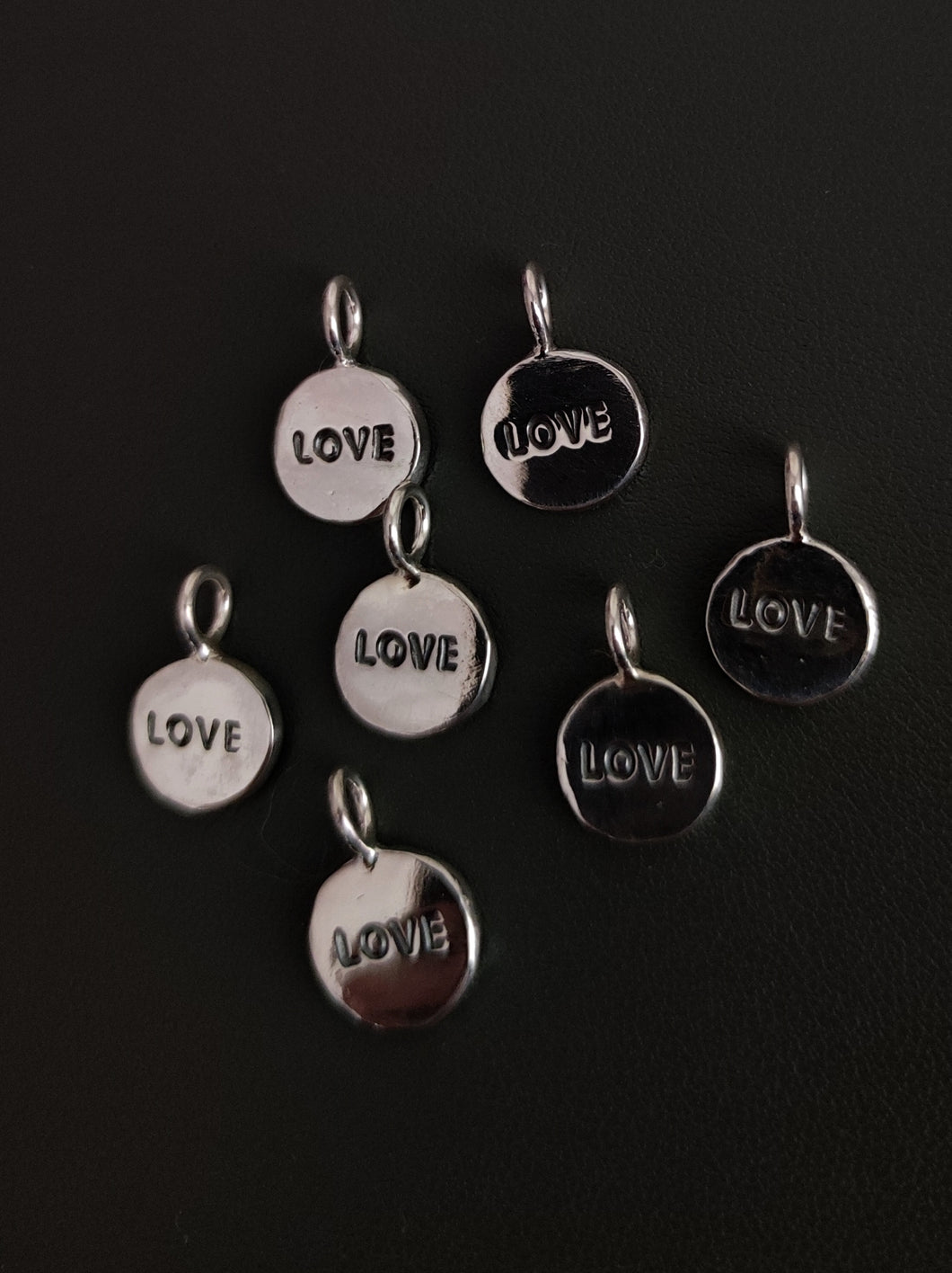 Five Kathrin Jona 'LOVE' charms, each with a loop for attachment and a diameter of your choice.