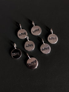 Five Kathrin Jona sterling silver 'LOVE' charms with a loop for easy attachment.