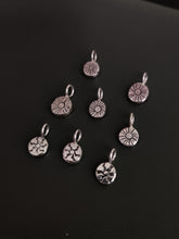 Load image into Gallery viewer, A group of small Kathrin Jona sterling silver charms on a black surface, including a &#39;SUN&#39; charm.
