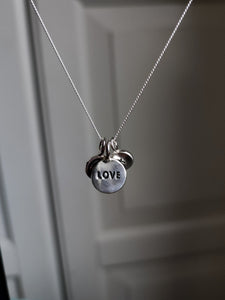 A Kathrin Jona sterling silver 'LOVE' charm necklace.