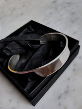 Load image into Gallery viewer, A Heavy Silver Cuff bracelet in a black box by Kathrin Jona.
