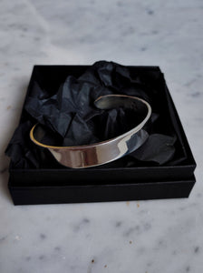 A Kathrin Jona Heavy Silver Cuff bracelet in a black box.