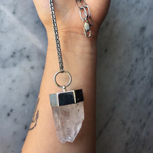 Load image into Gallery viewer, A person holding a Twin Point Quartz Statement Necklace by Kathrin Jona.
