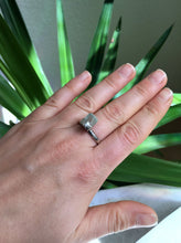 Load image into Gallery viewer, A woman&#39;s hand holding a Light Blue Aquamarine Ring by Kathrin Jona with a square cut stone.
