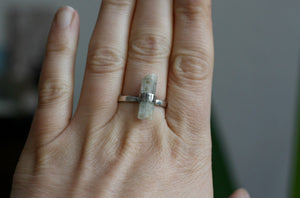 A woman's hand with a Kathrin Jona Aquamarine Crystal Ring on it.
