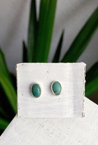 A pair of Kathrin Jona Small Turquoise Studs sitting on top of a white box.