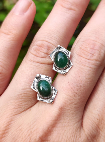 A pair of Green Shield Aventurine Earrings #2 by Kathrin Jona on a woman's hand.