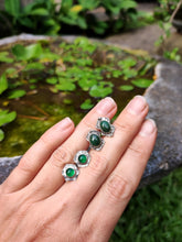 Load image into Gallery viewer, A hand holding Green Shield Aventurine Earrings #2 by Kathrin Jona with green jade stones.
