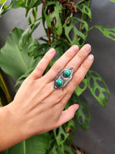 Load image into Gallery viewer, A hand holding a Green Shield Malachite Ring #3 by Kathrin Jona with a turquoise stone.
