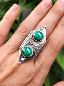 A woman's hand holding a Kathrin Jona Green Shield Malachite Ring #3.
