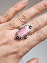 Load image into Gallery viewer, A woman&#39;s hand holding a Rhodochrosite Statement Ring by Kathrin Jona.
