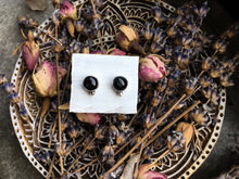 Load image into Gallery viewer, Sheen Obsidian stud earrings by Kathrin Jona on a plate.
