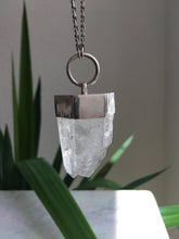 Load image into Gallery viewer, A Kathrin Jona Twin Point Quartz Statement Necklace with clear quartz stone hanging from a chain.
