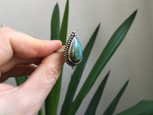 Load image into Gallery viewer, A hand holding a *Magic* Ring Turquoise by Kathrin Jona.

