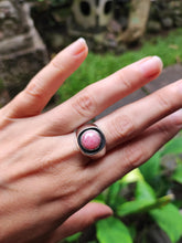 Load image into Gallery viewer, A woman&#39;s hand holding a Rhodochrosite Silver Signet Ring by Kathrin Jona.
