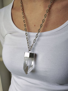 A woman wearing a Kathrin Jona Clear Quartz Point Statement Necklace.