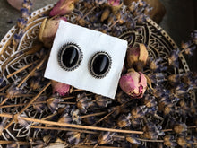 Load image into Gallery viewer, A pair of Kathrin Jona Onyx Stud Earrings No.2 on a plate.
