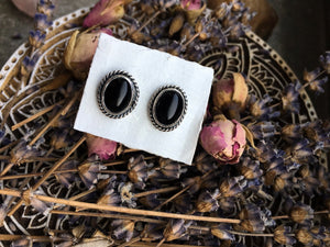 A pair of Kathrin Jona Onyx Stud Earrings No.2 on a plate.