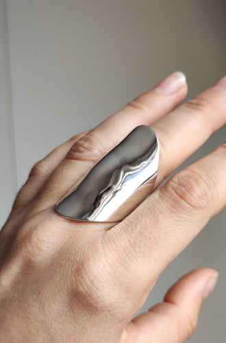 A woman's hand holding a Kathrin Jona Warrior Shield Ring.