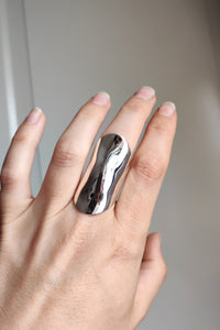 A woman's hand holding a Kathrin Jona Warrior Shield Ring.