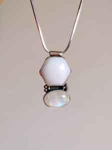 A Kathrin Jona Mother of Pearl and Moonstone Necklace with a white stone and a silver chain.