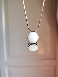 A Mother of Pearl and Moonstone Necklace hanging from a Kathrin Jona silver chain.