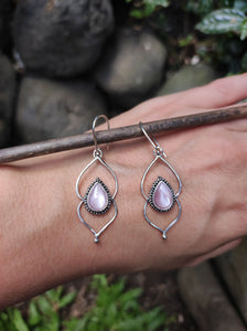 A hand holding a pair of Kathrin Jona Pink Mother of Pearl Drop Granulation Earrings.