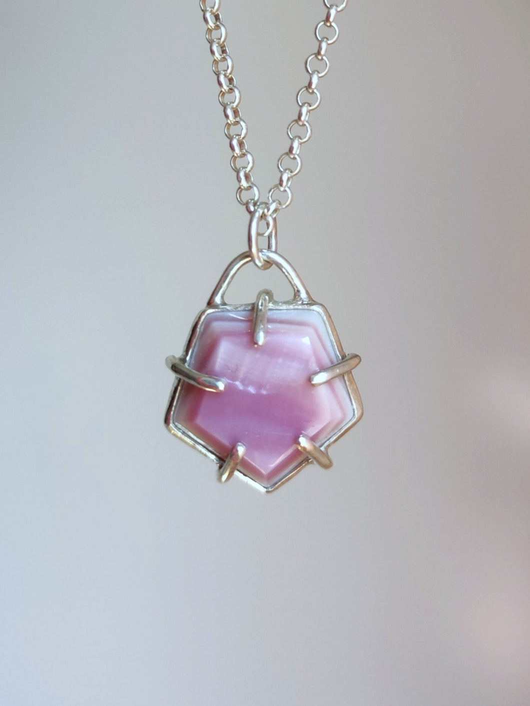 A Kathrin Jona Pentagon Mother of Pearl Necklace on a silver chain.
