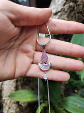 Load image into Gallery viewer, A hand holding a Mother of Pearl Moonstone Necklace with a pink stone pendant by Kathrin Jona.
