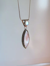 Load image into Gallery viewer, A Mother of Pearl Granulation Necklace by Kathrin Jona with a white stone and a silver chain.
