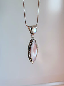 A Mother of Pearl Granulation Necklace by Kathrin Jona with a white stone and a silver chain.