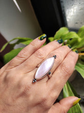 Load image into Gallery viewer, A hand holding a Kathrin Jona Mother of Pearl Ring adjustable.
