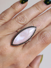 Load image into Gallery viewer, A woman&#39;s hand with a pink Kathrin Jona Mother of Pearl Granulation Ring adjustable.
