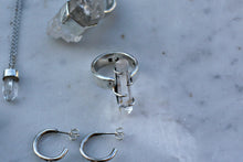 Load image into Gallery viewer, A Kathrin Jona clear quartz double point ring, earring, and necklace on a marble table.
