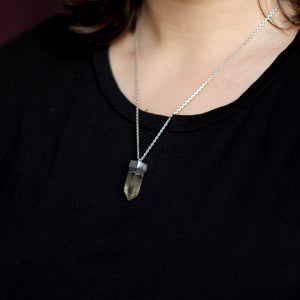 A woman wearing a Kathrin Jona Smoky Quartz Necklace.