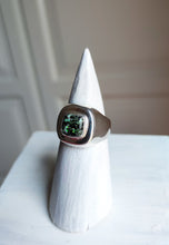 Load image into Gallery viewer, A Leopard Opal Silver Signet Ring S by Kathrin Jona with a green stone sitting on top of a pedestal.
