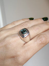 Load image into Gallery viewer, A woman&#39;s hand holding a Leopard Opal Silver Signet Ring S by Kathrin Jona with a green stone.
